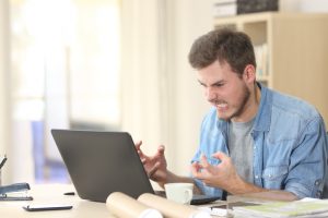 Entrepreneur angry and furious with laptop