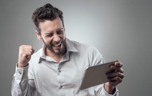 Cheerful smiling young man with tablet